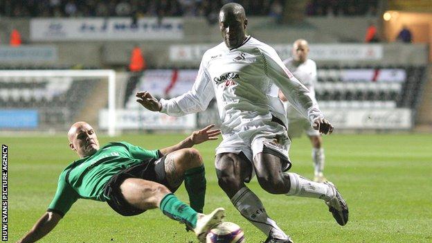 Swansea City's Kevin Austin is tackled by David Pipe of Bristol Rovers