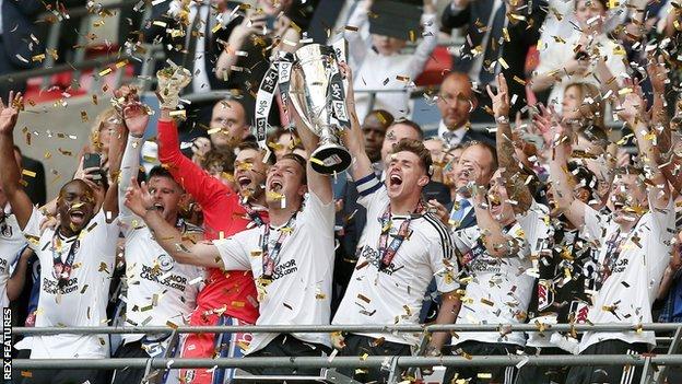 Fulham players celebrate with the trophy