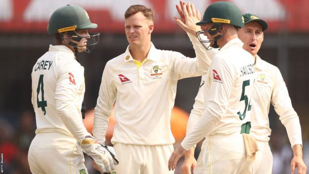 Matthew Kuhnemann of Australia celebrates taking a wicket against India