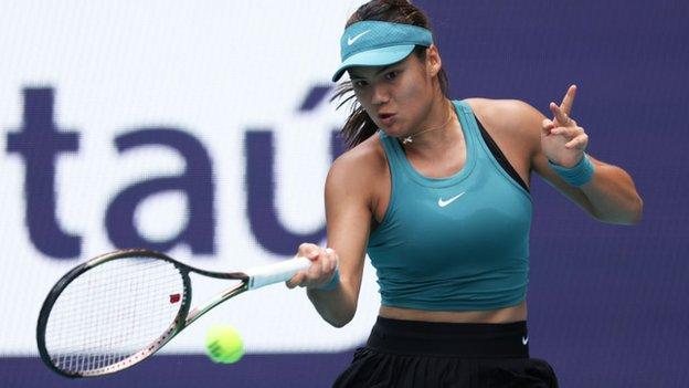 Emma Raducanu hits a return against Bianca Andreescu in their Miami Open first-round match