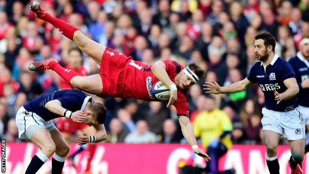 Wales fly-half Dan Biggar takes a tumble against Scotland