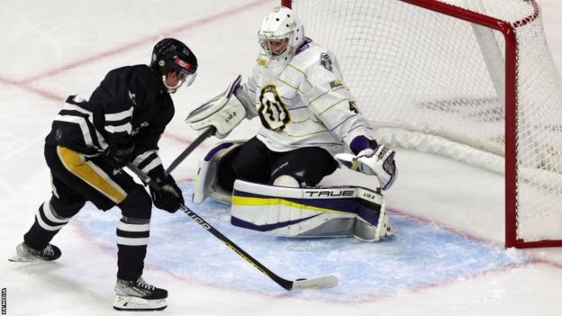 Nottingham Panthers' Didrik Henbrant takes on Manchester Storm goaltender Alexander Oldale during the Adam Johnson Memorial Game at Nottingham's Motorpoint Arena