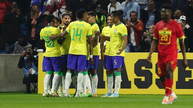 Brazil players celebrate their third goal against Ghana
