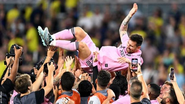 Team-mates hold up Inter Miami's Argentine forward Lionel Messi as they celebrate after winning the Leagues Cup