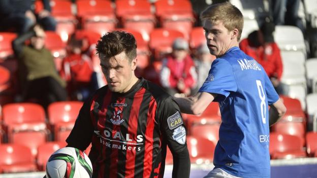 Diarmuid O'Carroll attempts to shield the ball from Rhys Marshall during Crusaders' 1-0 win over Glenavon at Seaview