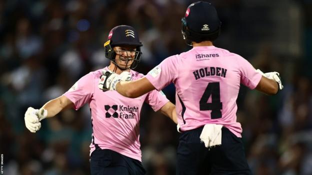 Middlesex players Max Holden and Jack Davies celebrate their victory over Surrey