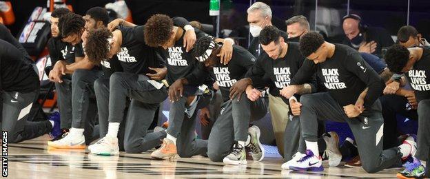 Utah Jazz and New Orleans Pelicans players kneel before their game