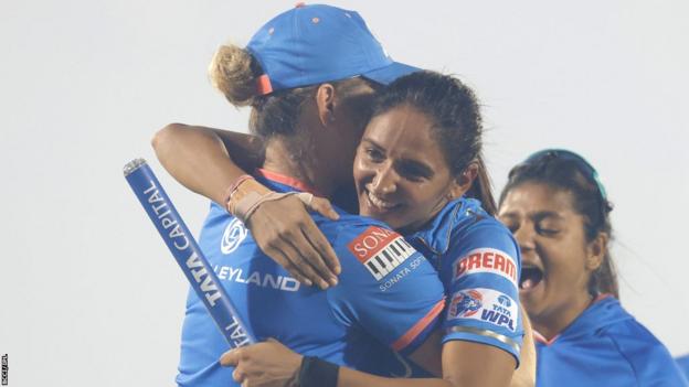 Mumbai Indians head coach Charlotte Edwards hugs captain Harmanpreet Kaur after they beat Delhi Capitals to win the inaugural Women's Premier League