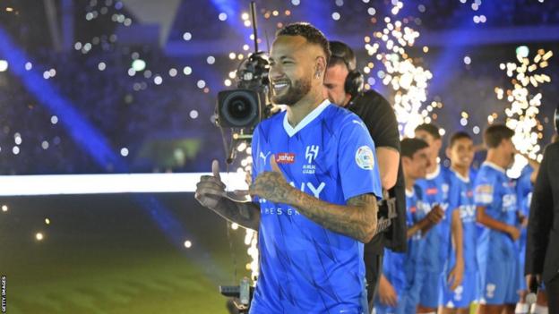 Brazil forward Neymar poses for photographs at his official unveiling as an Al-Hilal player