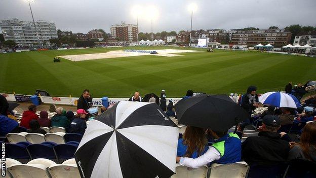 The umbrellas went up at Hove as the rain came down
