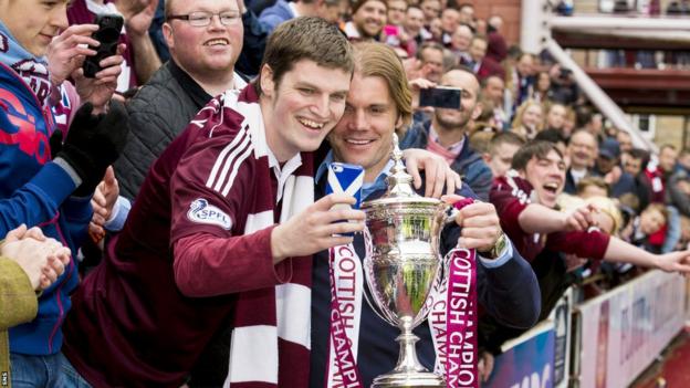 Robbie Neilson and a fan with the Scottish Championship trophy