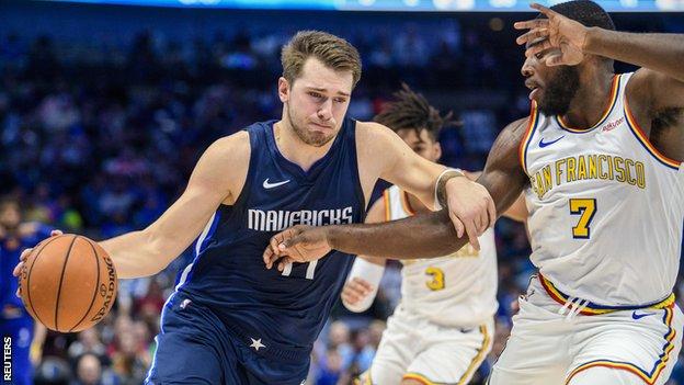 The Dallas Mavericks forward Luka Doncic (77) drives to the basket past the Golden State Warriors forward Eric Paschall (7).