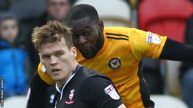 Frank Nouble of Newport County competes with Lincoln's Sean Raggett
