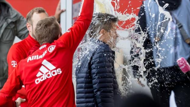 Jens Scheuer gets water thrown on him