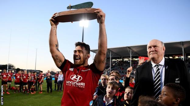 Crusaders captain Codie Taylor lifts the Super Rugby Aotearoa trophy