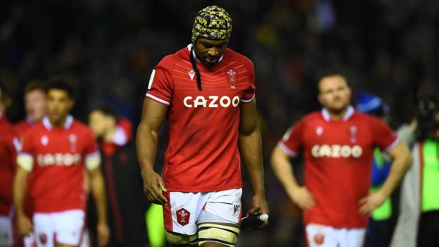 Christ Tshiunza of Wales looks dejected after the defeat in Scotland