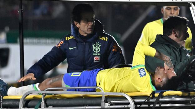 Neymar holds his head after being taken off injured during Brazil's loss to Uruguay