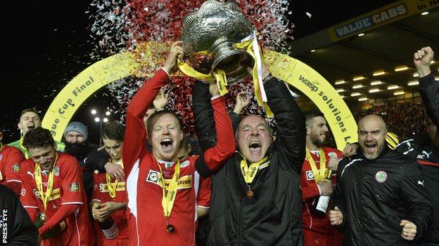 Cliftonville captain George McMullan and manager Tommy Breslin celebrate with the League Cup last season