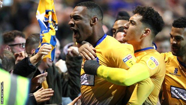 Krystian Pearce celebrates scoring for Mansfield