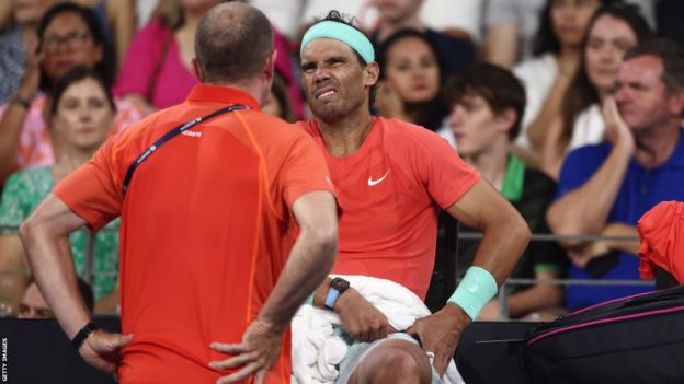 Rafael Nadal receives treatment after sustaining an injury at the Brisbane International