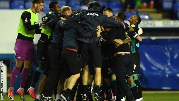 Swansea players and staff celebrate after claiming a play-off place in remarkable fashion