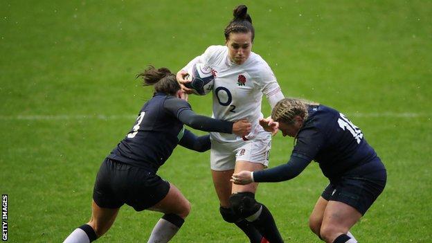 England's Emily Scarratt is tackled by two Scottish players