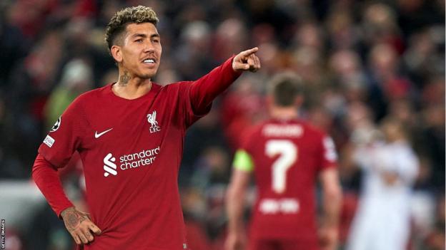 Roberto Firmino gestures towards one of his Liverpool team-mates at Anfield
