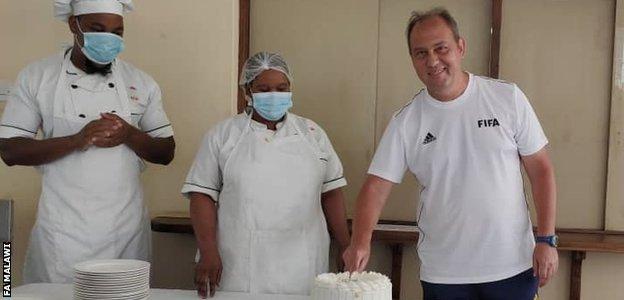 Mario Marinica cuts a birthday cake