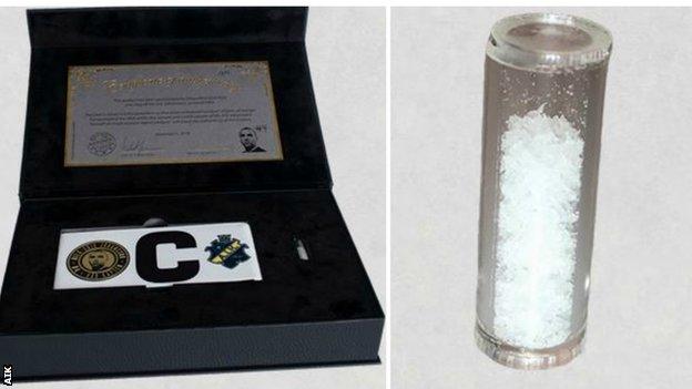 The test tube of crystallised DNA (right) comes as part of a gift set including a captain's armband with Johansson's face on it and a certificate of authenticity