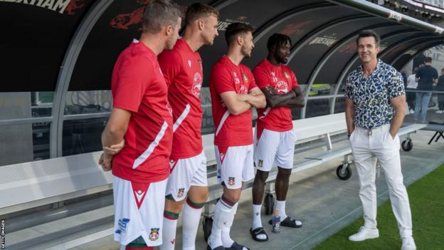 Wrexham owner Rob McElhenney speaks to players before the match