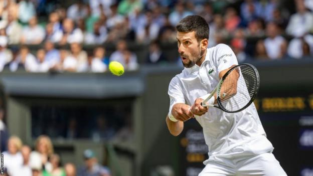 Novak Djokovic returns a shot in the Wimbledon final