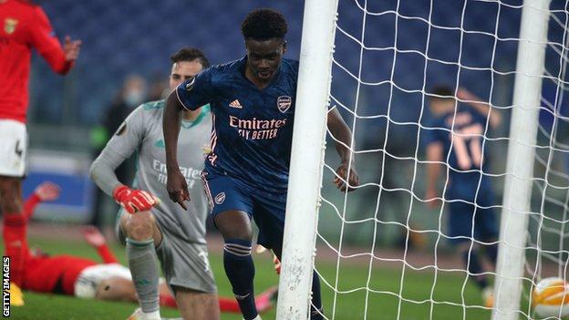 Bukayo Saka celebrates scoring for Arsenal against Benfica