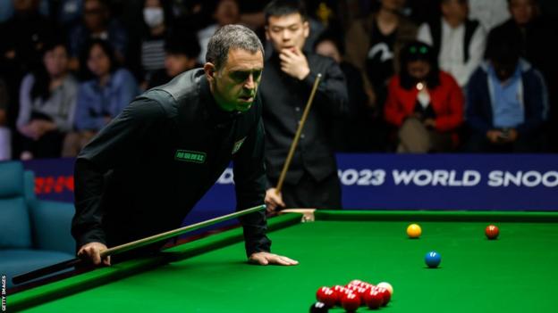 Ronnie O'Sullivan of England reacts in the third round match against Pang Junxu of China