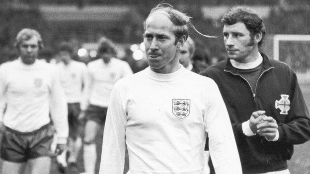 England's Bobby Charlton walks out Wembley alongside Northern Ireland captain Terry Neill in 1970
