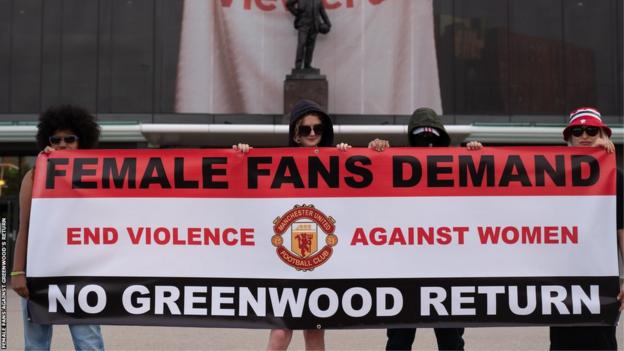 The Female Fans Against Greenwood's Return group hold up a banner outside Old Trafford
