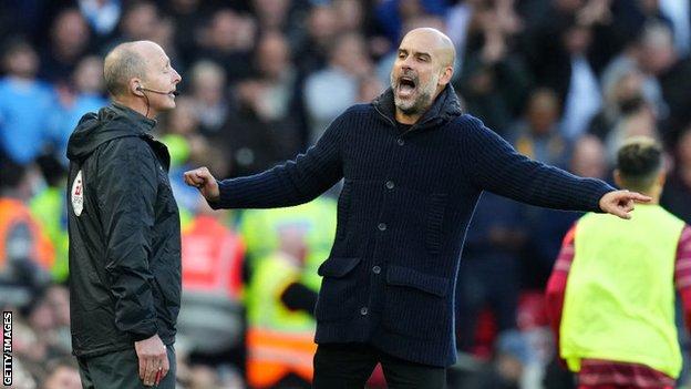 Man City boss Pep Guardiola (right) and fourth official Mike Dean (left)