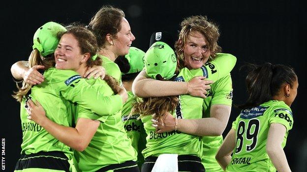 Sammy-Jo Johnson is mobbed after taking the wicket which sealed Sydney Thunder's place in the final