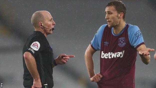 Referee Mike Dean sends off West Ham's Tomas Soucek during the Premier League game with Fulham
