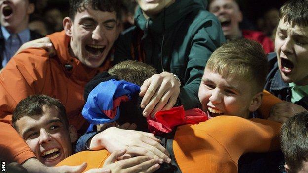 Dundee United's Pavol Safranko gives his shirt to a fan at full time