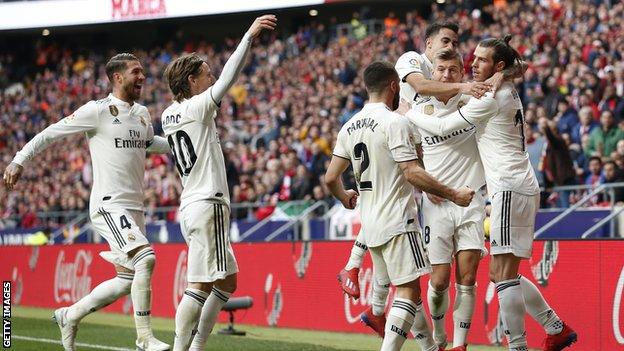 Gareth Bale is hugged by teammates after scoring his 100th Real Madrid goal