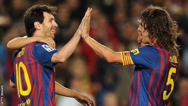 Lionel Messi and Carlos Puyol