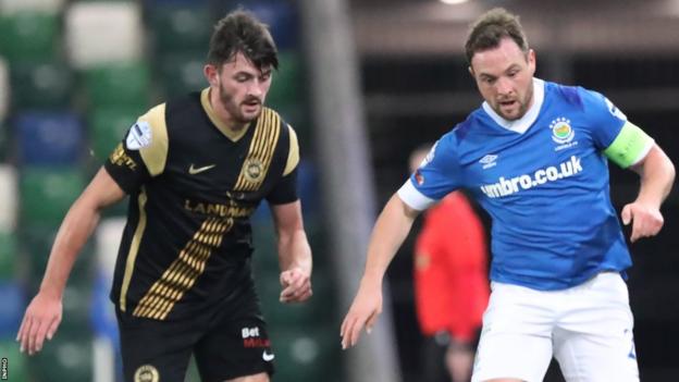 Larne's Lee Bonis and Linfield skipper Jamie Mulgrew contest possession