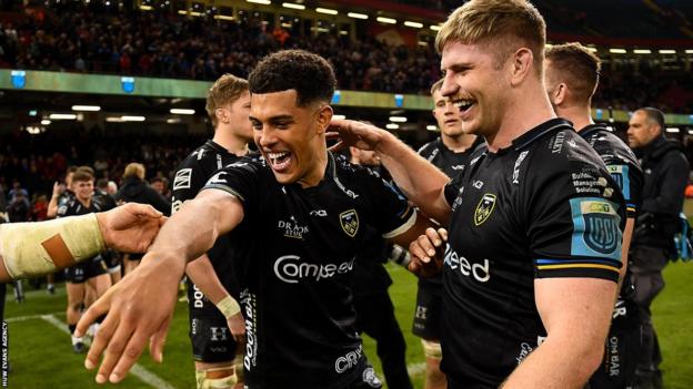 Rio Dyer (L) and Aaron Wainwright celebrate Dragons beating Scarlets in April, 2023