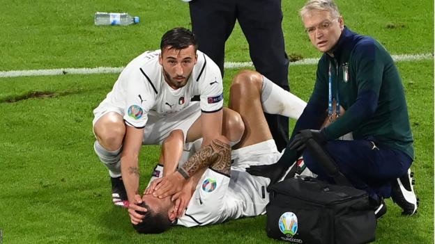 Italy defender Leonardo Spinazzola awaits treatment after injuring his Achilles tendon