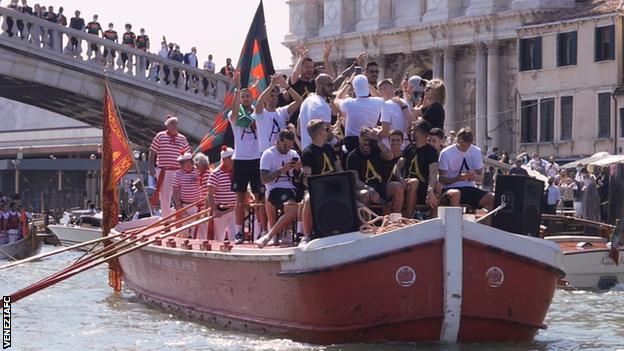 Venezia FC players celebrate their promotion with a unique parade through the city