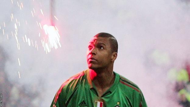 AC Milan goalkeeper Dida watches as a flare falls on him in the 2005 Champions League quarter-final against AC Milan