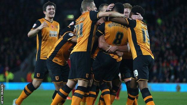 Hull City players celebrate scoring a goal