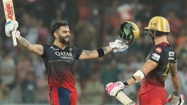 Virat Kohli raises his bat