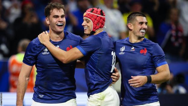 Damian Penaud of France celebrates scoring his sides fourth try with team mates Louis Bielle-Biarrey and Thomas Ramos