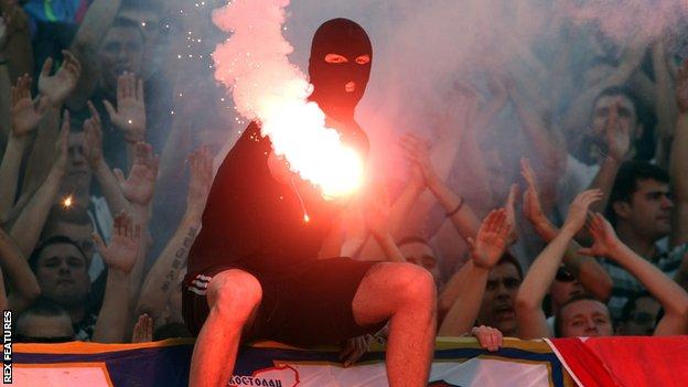 A Red Star fan lights a flare during a May 2013 match